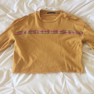 A mustard yellow cropped long sleeve